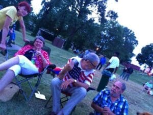 Group of people enjoying a picnic outdoors.