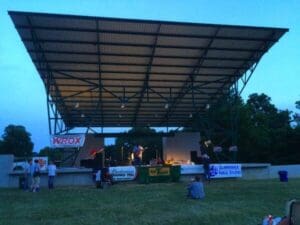 Outdoor stage with band and audience