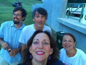 Four friends smile for a photo.