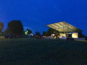 Outdoor stage under a night sky.