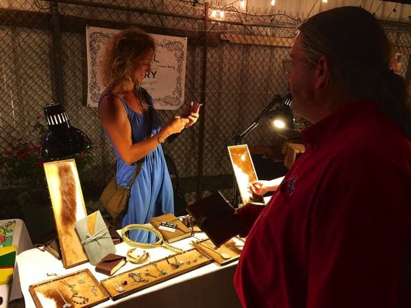 Vendor showing jewelry to customer