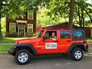 Red Jeep with tour company logo.