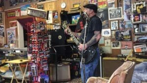 Deak Harp performing for visitors to his shop in Clarksdale