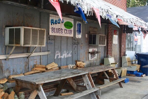 Vintage blues club entrance with stacked firewood
