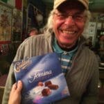Man holding a box of Cailler chocolate.