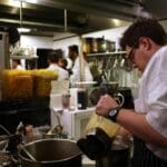 Parlor Market Sous Chef Jesse Houston busy at work during FRENCH NIGHT MADIDI. Photo by Rachel Bush.