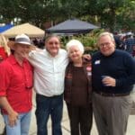 Four men and one woman smiling for a photo.