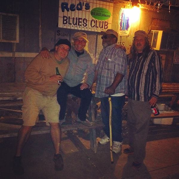 Friends posing outside a blues club