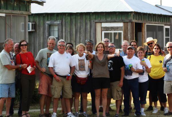 Friends gathered outside rustic building