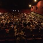 Audience watching a movie in a theater.