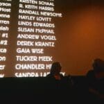A screen with names of actors and actresses.