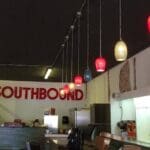 Red sign with "Southbound" and hanging lights.