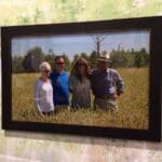 Framed photo of four people in a field.