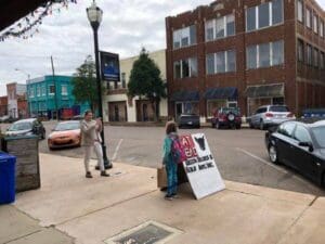 Mom Jenny taking Mia's photo outside Cat Head Delta Blues & Folk Art in Clarksdale