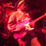 Man playing electric guitar in concert