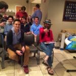 Group of young men sitting and talking.