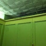 Green walls and a white tiled ceiling.
