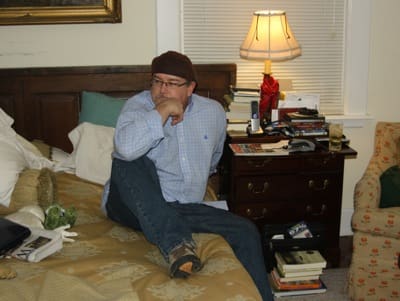 Man in casual attire on bed