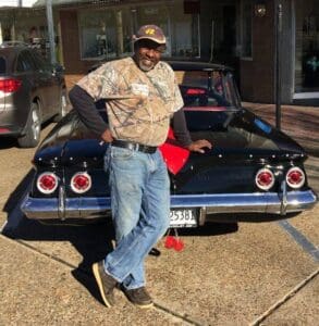 Big J Milton Johnson owner of Johnson Plumbing in Cleveland, Mississippi by his Chevy 1961 Bel Air