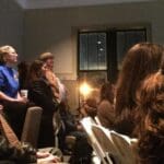 Group of people seated in a room.