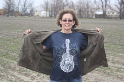 Person displaying graphic tee outdoors