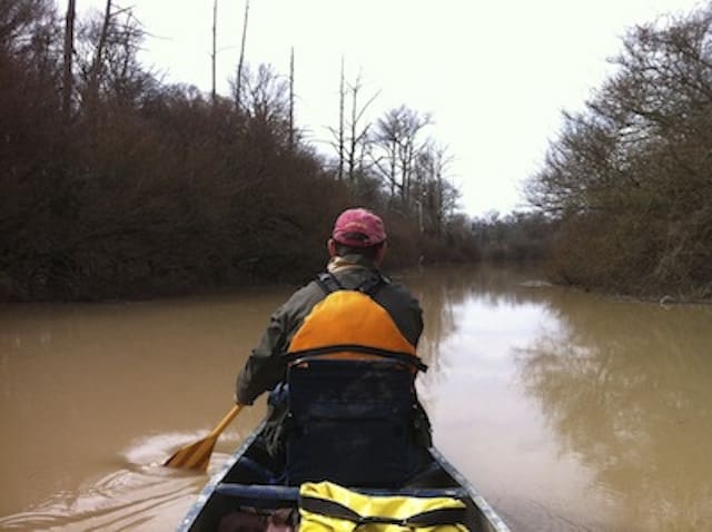 Man in canoe on overcast day