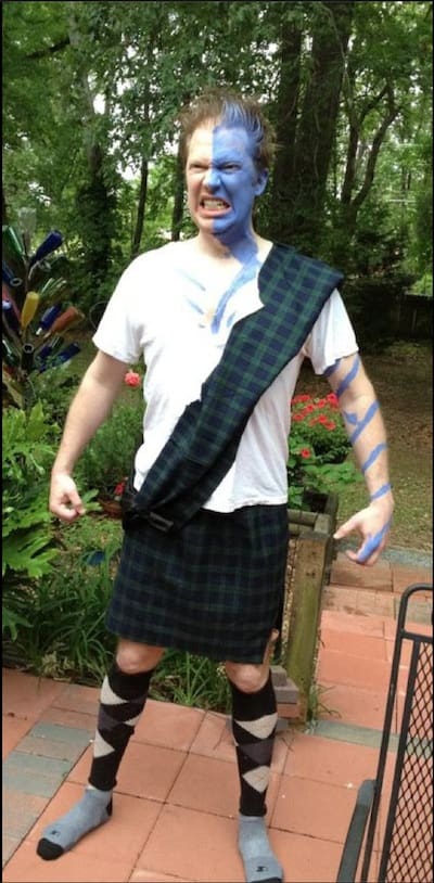 Individual posing outdoors in Scottish attire