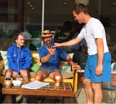 Three people socializing at a café