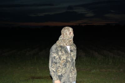 Man wearing camouflage in field