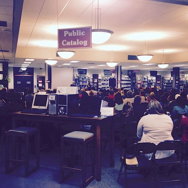 Audience gathered in library public catalog section