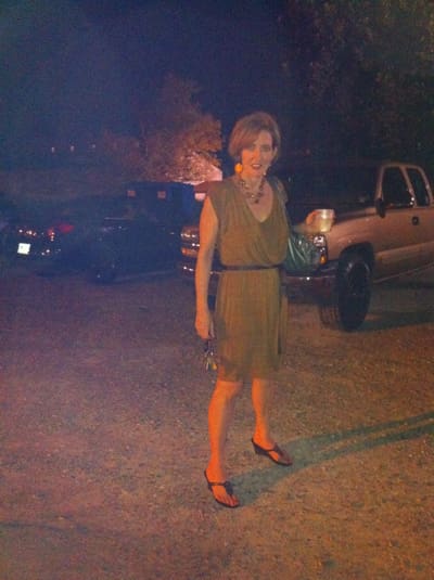 Nighttime scene with woman and parked vehicles