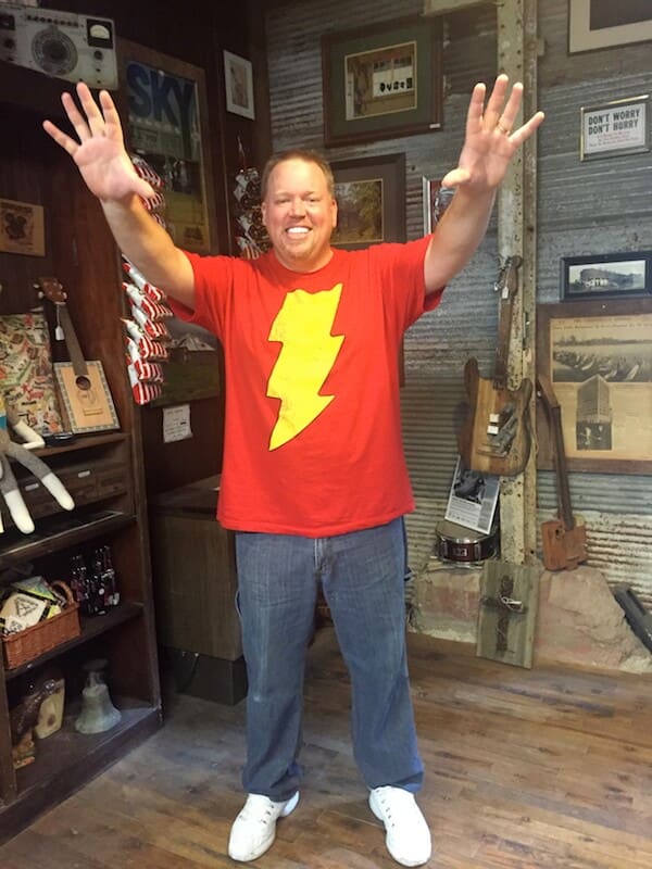 Man in red lightning bolt shirt smiling