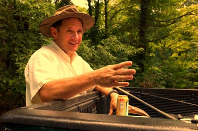 Man gesturing in pickup truck bed
