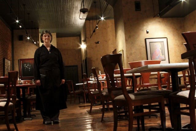 Faithful Server and the go to woman at Madidi Peggy Lloyd standing in the empty dining room on the final night of Madidi. Peggy was employed by the restaurant from day one to the final day. Photo by Delta Bohemian