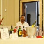 Man pouring drinks at a bar party.