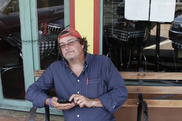 Casual man with glasses at cafe entrance