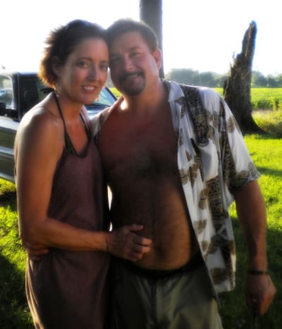 Couple posing outdoors in summer attire
