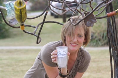 Woman posing outdoors with decorative metalwork