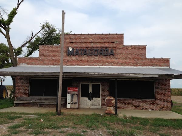 Old brick structure with overgrown grass