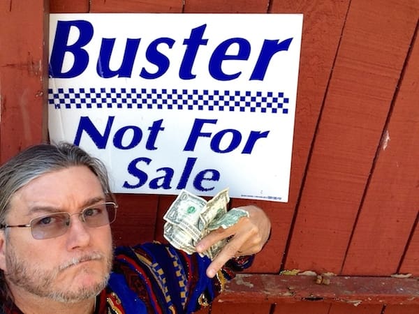 Person with money in front of red wall