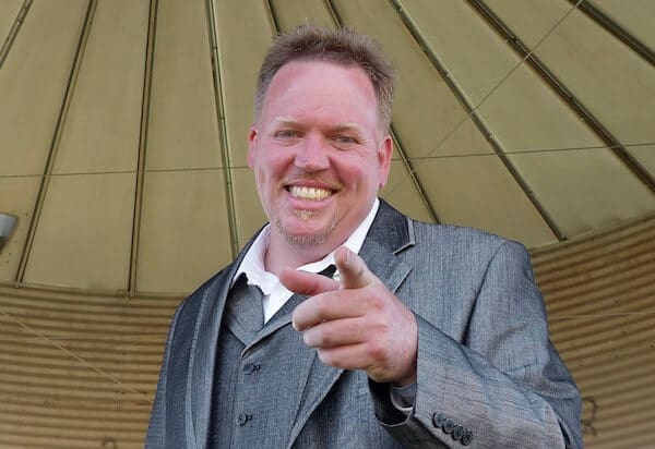 Man pointing and smiling under dome ceiling