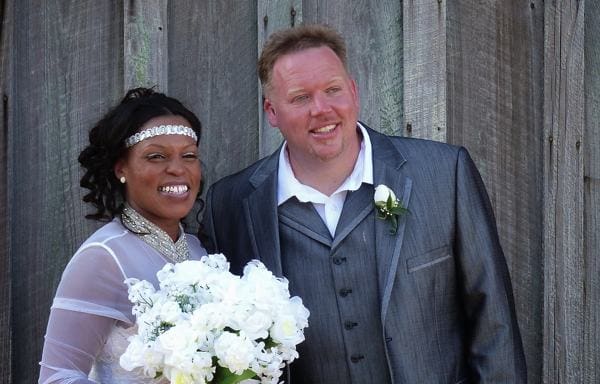 Bride and groom smiling outdoors