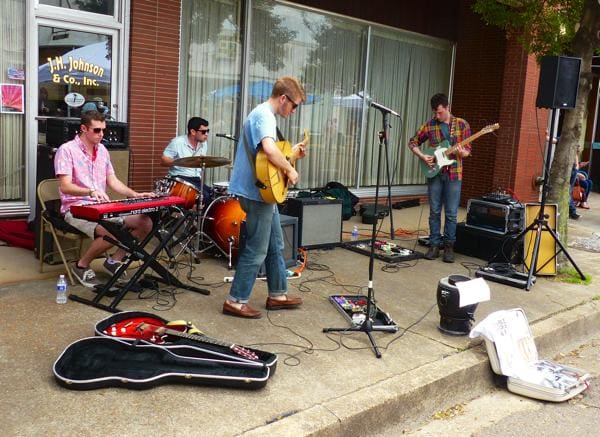 Band playing live music on sidewalk