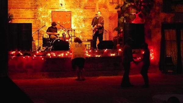 People dancing in dimly lit venue