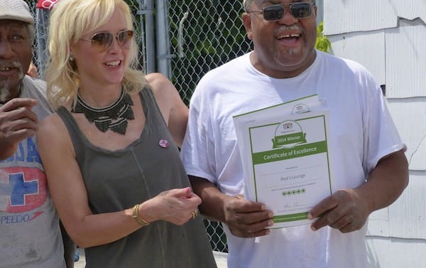 Red Paden showing off his tripadvisor award with Dr. Dingo and Melissa Townsend