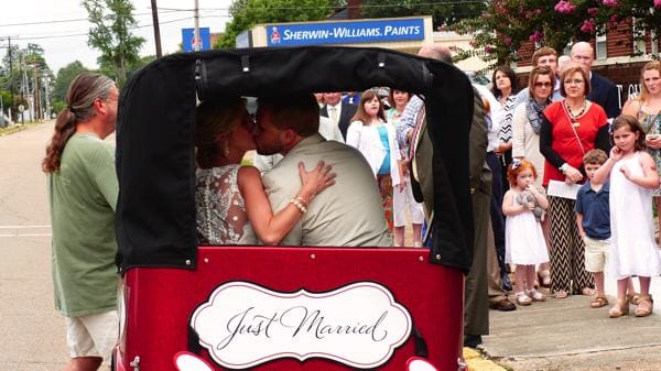 Just married couple kissing in carriage