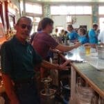 Group of people at a bar with drinks.