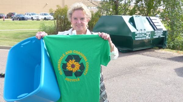 Individual promoting recycling with green t-shirt
