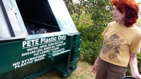 Recycle Manager Marc Taylor beside a bin in Clarksdale's Walmart parking lot.