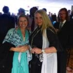 Women in formal wear at a wedding reception.